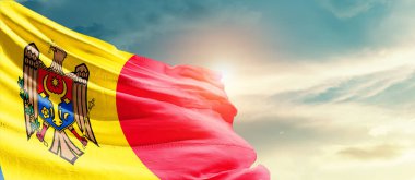 Moldova waving flag in beautiful sky with sun