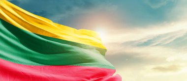 Lithuania waving flag in beautiful sky with sun