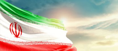 Iran waving flag in beautiful sky with sun