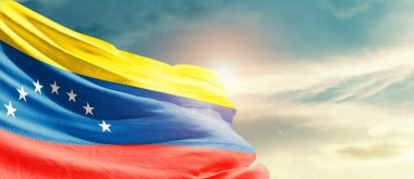  Venezuela waving flag in beautiful sky with sun