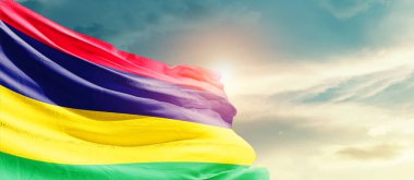 Mauritius waving flag in beautiful sky with sun