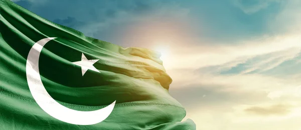 Pakistan waving flag in beautiful sky with sun