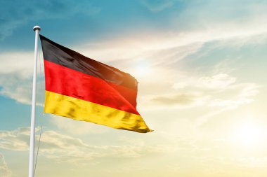 Germany waving flag in beautiful sky with sun