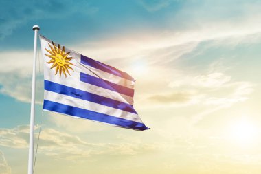 Uruguay waving flag in beautiful sky with sun