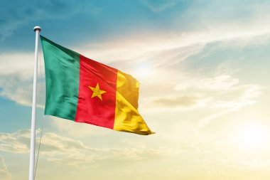 Cameroon waving flag in beautiful sky with sun