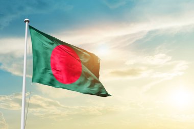 Bangladesh waving flag in beautiful sky with sun