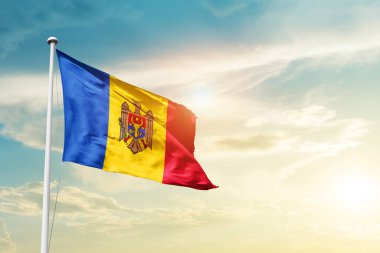 Moldova waving flag in beautiful sky with sun