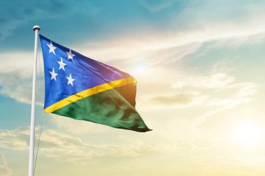 Solomon Islands waving flag in beautiful sky with sun