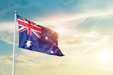 Australia waving flag in beautiful sky with sun
