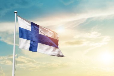 Finland waving flag in beautiful sky with sun