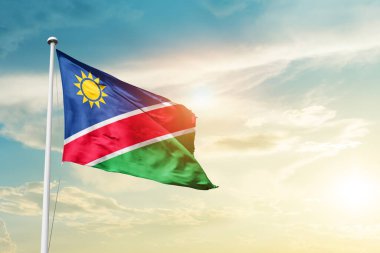 Namibia waving flag in beautiful sky with sun