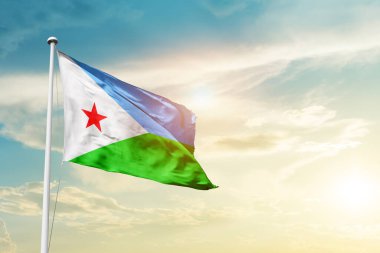 Djibouti waving flag in beautiful sky with sun