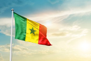 Senegal waving flag in beautiful sky with sun