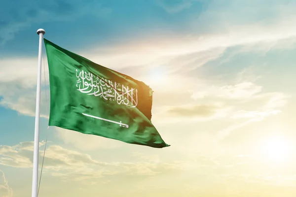 Saudi Arabia waving flag in beautiful sky with sun