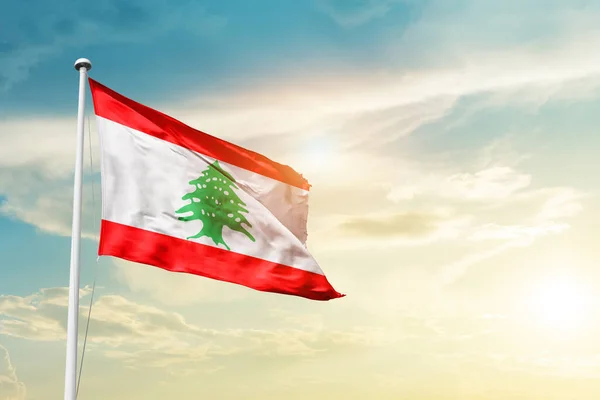 Lebanon waving flag in beautiful sky with sun