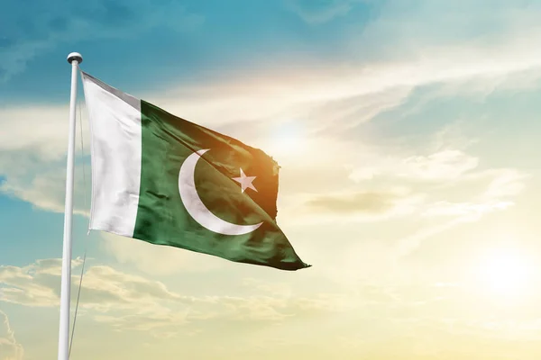 Pakistan waving flag in beautiful sky with sun