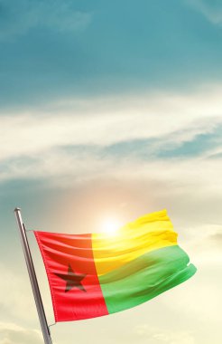 Guinea-Bissau waving flag in beautiful sky with sun