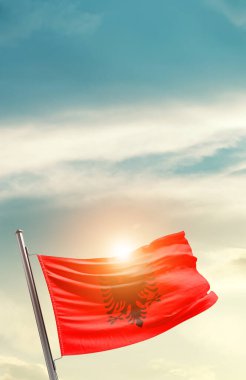 Albania waving flag in beautiful sky with sun