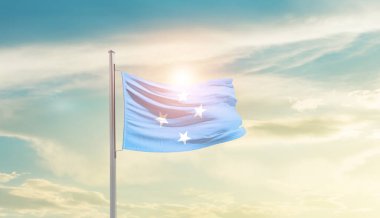 Micronesia waving flag in beautiful sky with sun