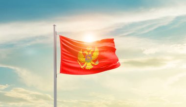 Montenegro waving flag in beautiful sky with sun