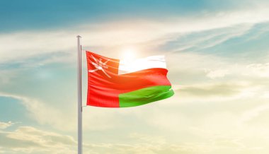 Oman waving flag in beautiful sky with sun