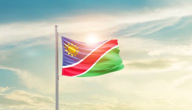 Namibia waving flag in beautiful sky with sun