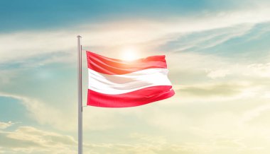 Austria waving flag in beautiful sky with sun