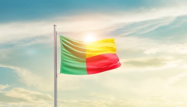 Benin waving flag in beautiful sky with sun