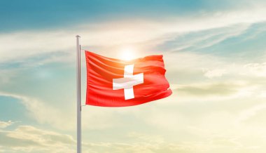 Switzerland waving flag in beautiful sky with sun