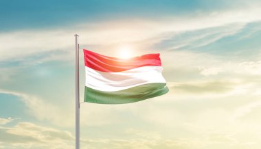 Hungary waving flag in beautiful sky with sun