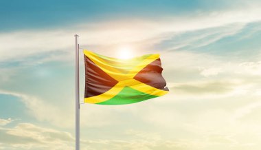 Jamaica waving flag in beautiful sky with sun