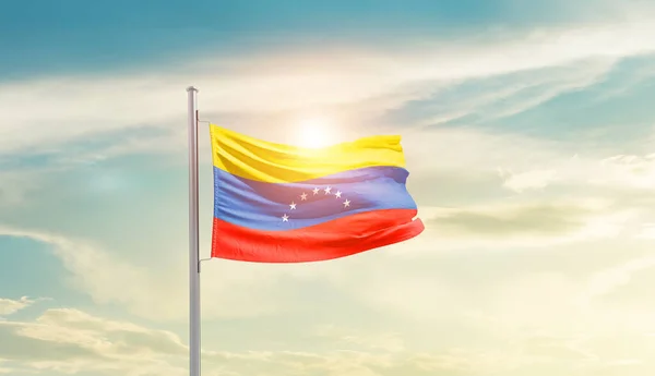 stock image Venezuela waving flag in beautiful sky with sun