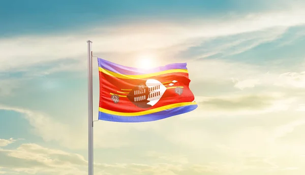 stock image Eswatini waving flag in beautiful sky with sun