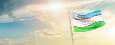 Uzbekistan waving flag in beautiful sky with sun