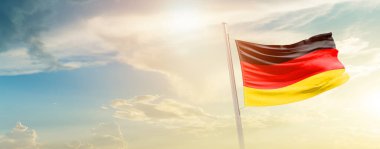 Germany waving flag in beautiful sky with sun