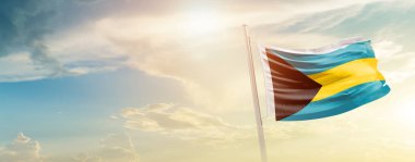 Bahamas waving flag in beautiful sky with sun