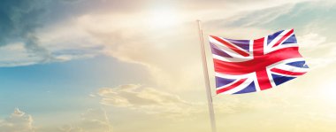 United Kingdom waving flag in beautiful sky with sun