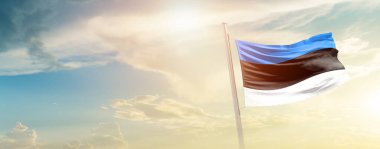 Estonia waving flag in beautiful sky with sun