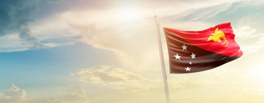 Papua New Guinea waving flag in beautiful sky with sun