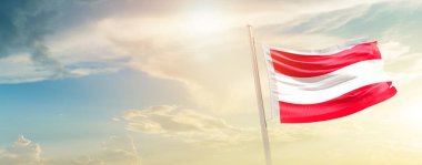 Austria waving flag in beautiful sky with sun