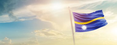 Nauru waving flag in beautiful sky with sun