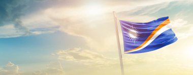 Marshall Islands waving flag in beautiful sky with sun
