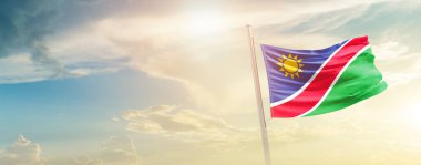 Malta waving flag in beautiful sky with sun