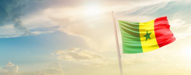 Senegal waving flag in beautiful sky with sun