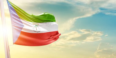 Ekvator Gine bayrağı bulutlu ve güneşli gökyüzüne karşı