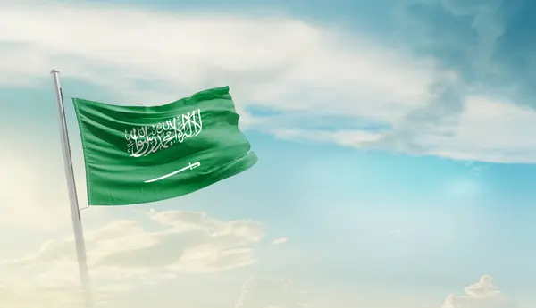 stock image Saudi Arabia waving flag against blue sky with clouds
