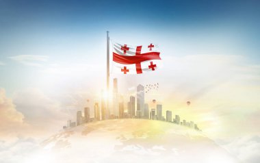 Georgia bayrağı şehir manzarasına karşı dalgalanıyor