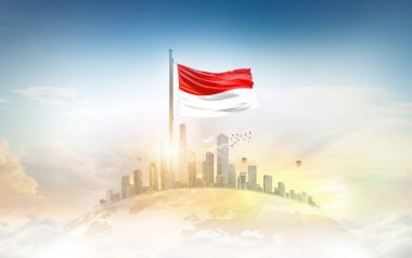 Endonezya bayrağı şehir manzarasına karşı dalgalanıyor