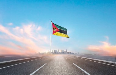 flag of Mozambique on the highway with cityscape view