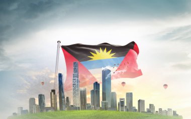 Antigua ve Barbuda ulusal bayrağı gökyüzünde bulutlarla dalgalanırken, arka planda büyük şehir mimarisi 